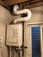 Before – Unnecessary 4” vent configuration on older tankless. Installed new Rinnai RUR 199IN